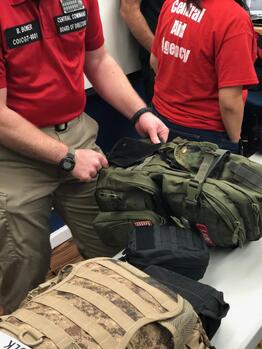RRT and CERT Personnel attach new first aid kits to their packs at a meeting in November 2019.