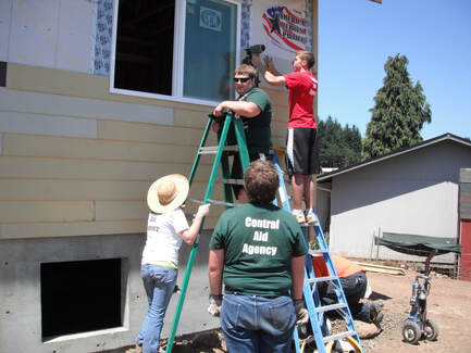 Sector 2 personnel help build a Habitat house during a community service project.