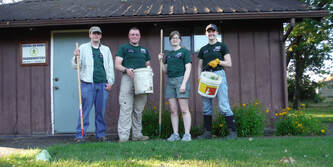 Central Aid Agency personnel pose in front of Sector 2 HQ during a Spring work party.