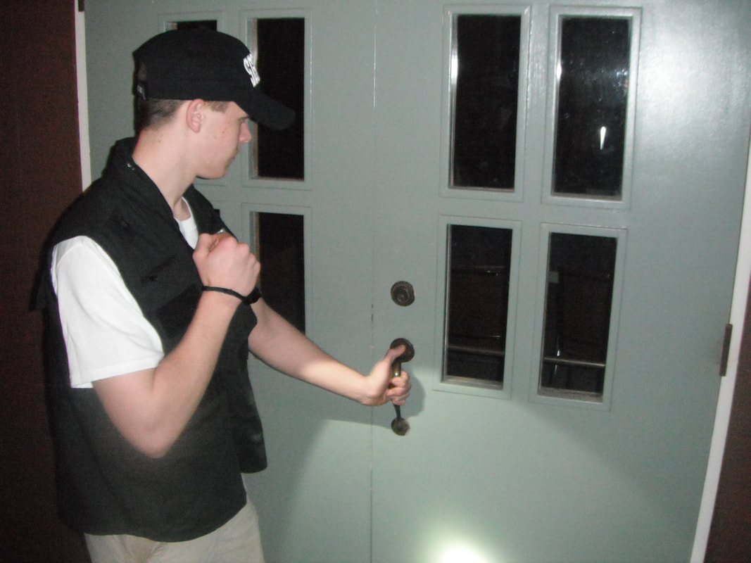 Civil Patrol volunteers check a door at the JC First Christian Church during a patrol in 2012.