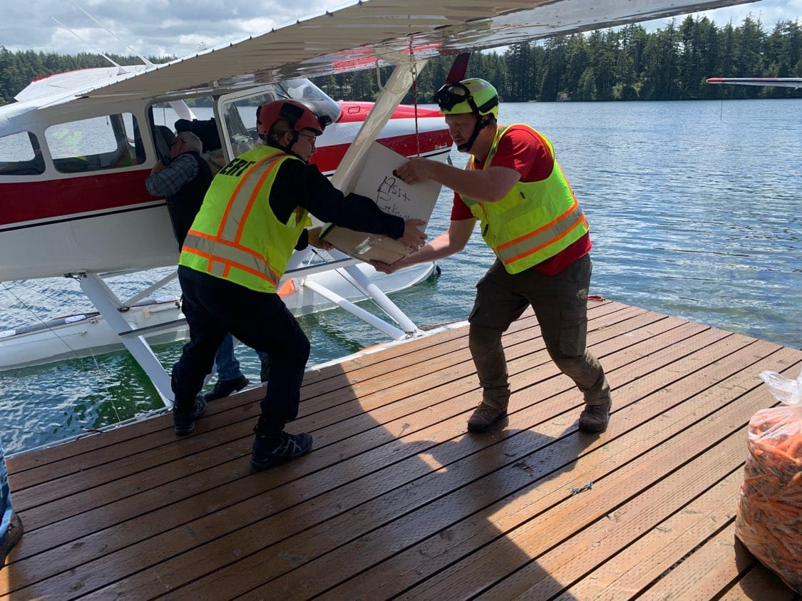Personnel unloading a seaplane