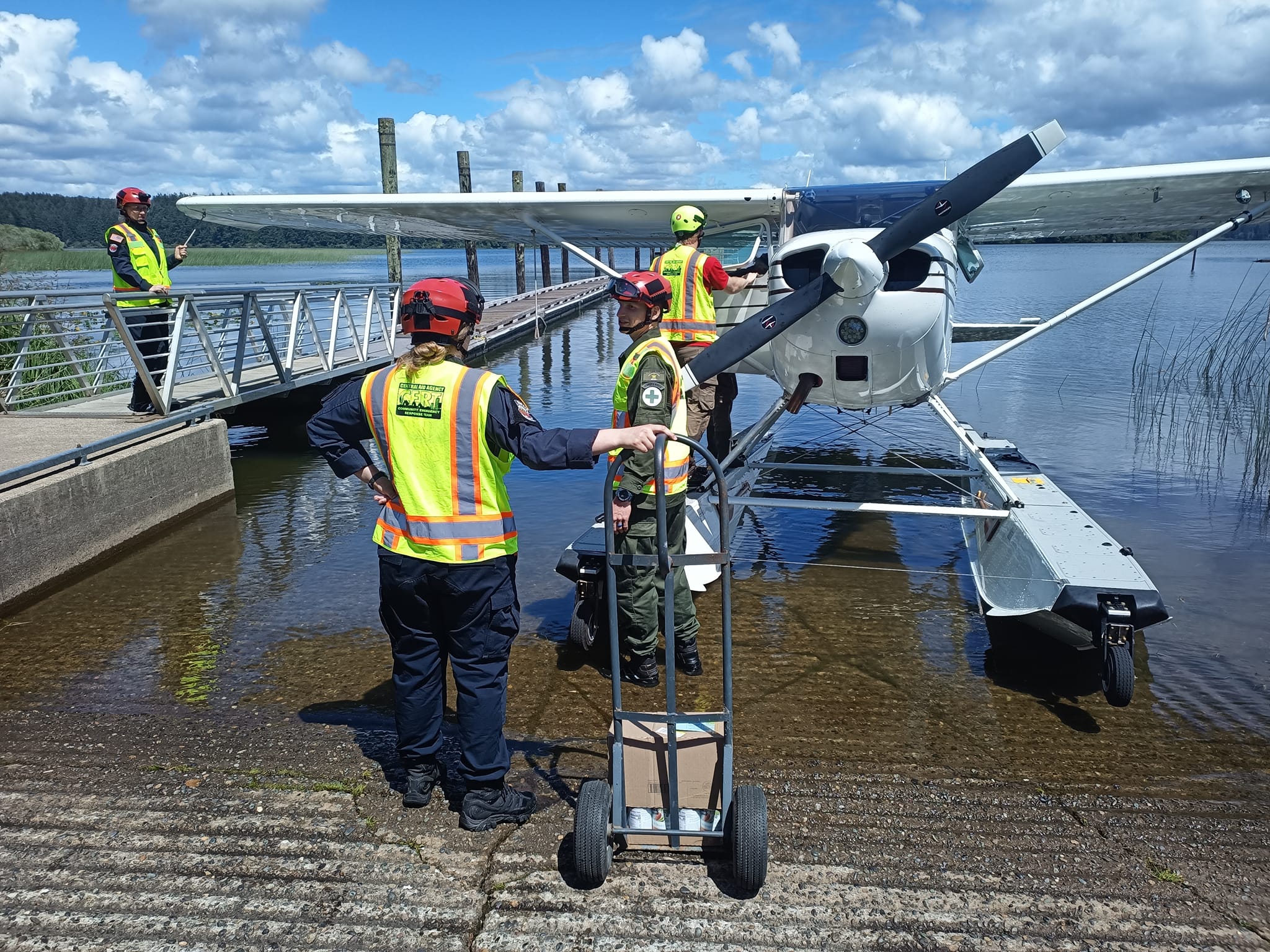 Emergency Response personnel unload a seaplane during an exercise.
