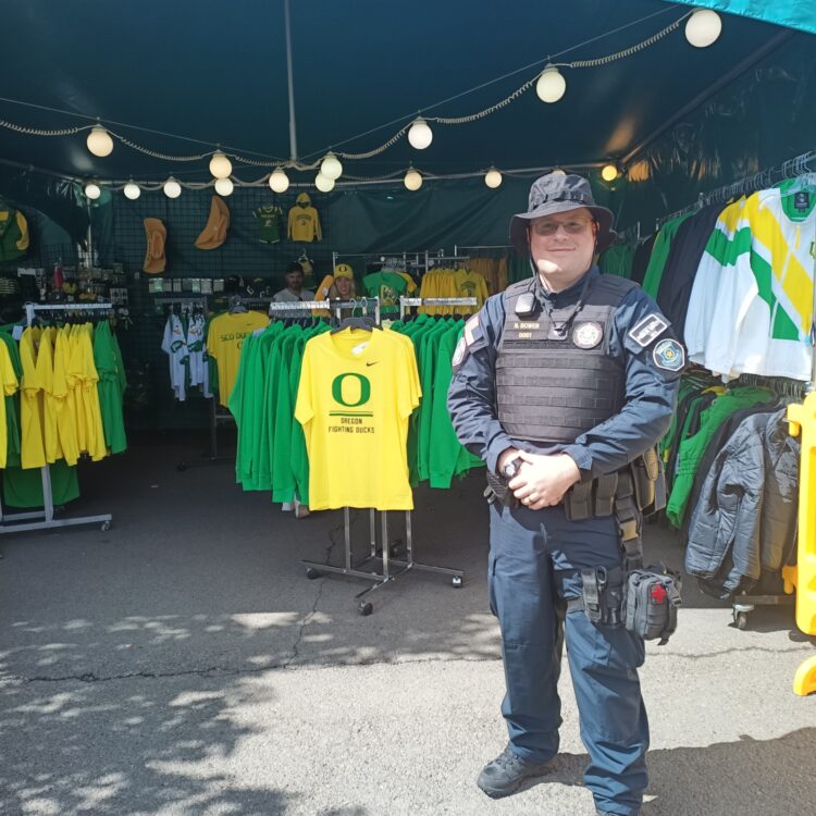 Male USO Agent on duty outside during a UO Home Game at Autzen Stadium.